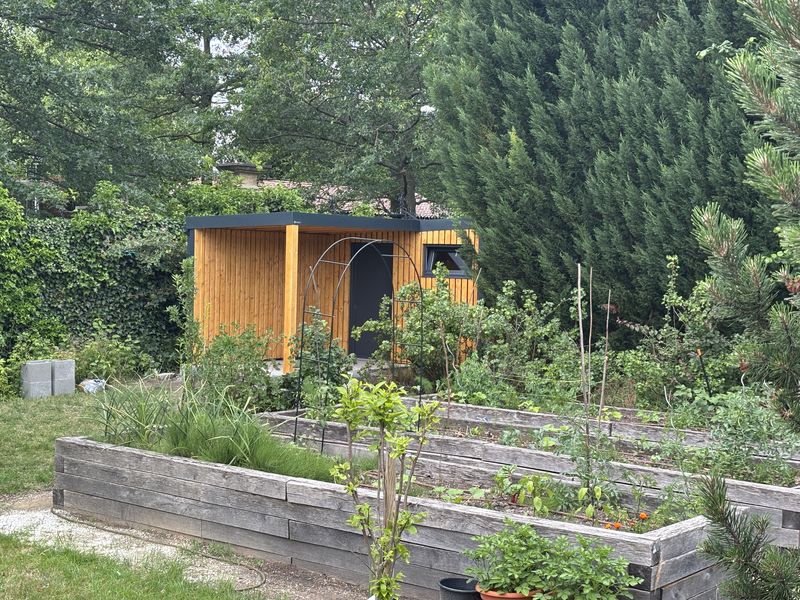 Domček z diaľky, vyvýšené záhony v popredí